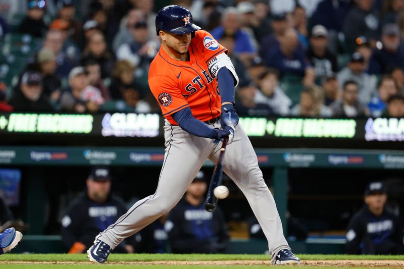 May 10, 2024; Detroit, Michigan, USA;  Houston Astros catcher Yainer Diaz (21) hits a sacrifice fly to score a run in the eighth inning against the Detroit Tigers at Comerica Park. Mandatory Credit: Rick Osentoski-USA TODAY Sports