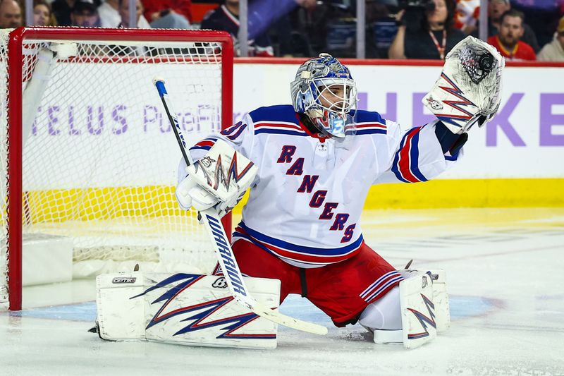 Nov 21, 2024; Calgary, Alberta, CAN; New York Rangers goaltender Igor Shesterkin (31) makes a save against the Calgary Flames during the second period at Scotiabank Saddledome. Mandatory Credit: Sergei Belski-Imagn Images