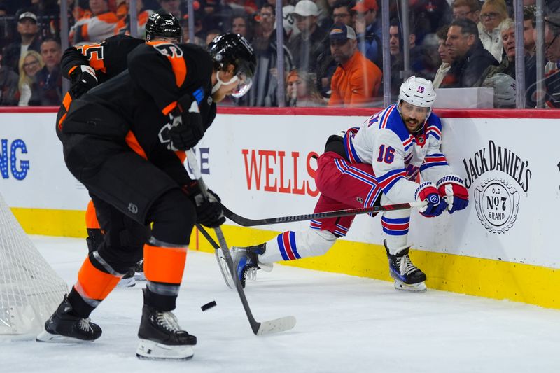 Nov 29, 2024; Philadelphia, Pennsylvania, USA; New York Rangers center Vincent Trocheck (16) reaches for the puck against Philadelphia Flyers defenseman Travis Sanheim (6) in the second period at Wells Fargo Center. Mandatory Credit: Kyle Ross-Imagn Images