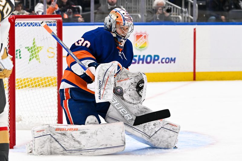 Jan 23, 2024; Elmont, New York, USA;  New York Islanders goaltender Ilya Sorokin (30) makes a save against the Vegas Golden Knights during the first period at UBS Arena. Mandatory Credit: Dennis Schneidler-USA TODAY Sports