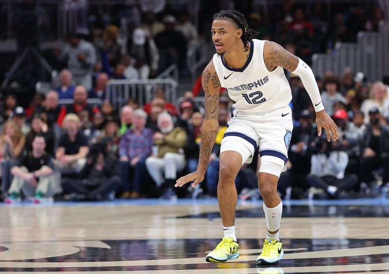 ATLANTA, GEORGIA - DECEMBER 23:  Ja Morant #12 of the Memphis Grizzlies reacts after shooting over Trae Young #11 of the Atlanta Hawks during the fourth quarter at State Farm Arena on December 23, 2023 in Atlanta, Georgia.  NOTE TO USER: User expressly acknowledges and agrees that, by downloading and/or using this photograph, user is consenting to the terms and conditions of the Getty Images License Agreement. (Photo by Kevin C. Cox/Getty Images)