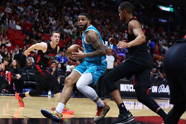 MIAMI, FLORIDA - DECEMBER 13: Miles Bridges #0 of the Charlotte Hornets drives against Orlando Robinson #25 of the Miami Heat during the third quarter at Kaseya Center on December 13, 2023 in Miami, Florida. NOTE TO USER: User expressly acknowledges and agrees that, by downloading and or using this photograph, User is consenting to the terms and conditions of the Getty Images License Agreement. (Photo by Megan Briggs/Getty Images)