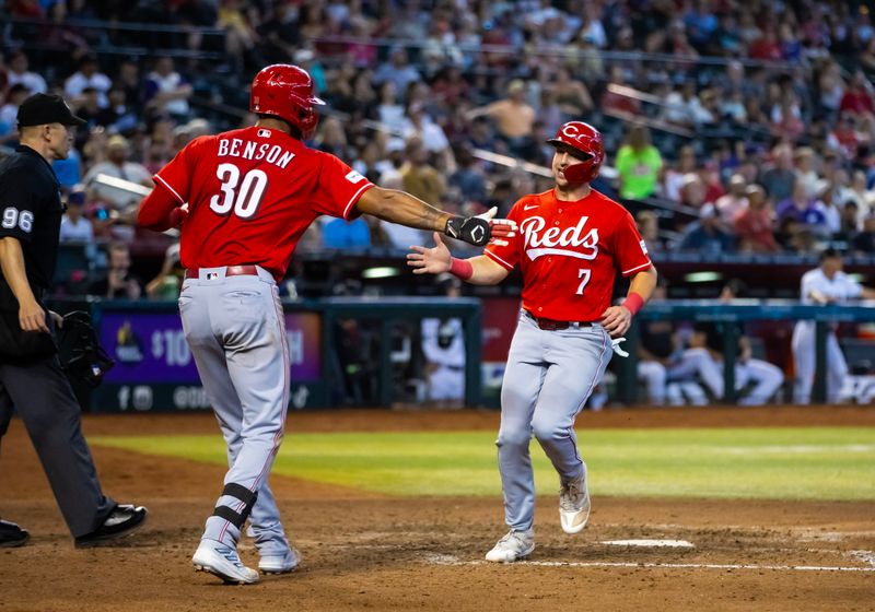 Aug 27, 2023; Phoenix, Arizona, USA; Cincinnati Reds infielder Spencer Steer celebrates with teammate Will Benson after scoring in the seventh inning against the Arizona Diamondbacks at Chase Field. Mandatory Credit: Mark J. Rebilas-USA TODAY Sports