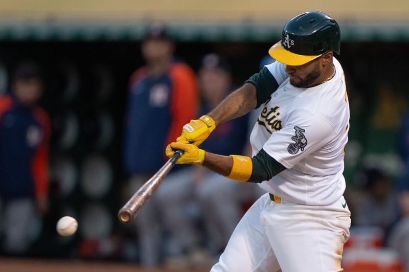 Jul 23, 2024; Oakland, California, USA;  Oakland Athletics third base Abraham Toro (31) hits an RBI single during the fifth inning against the Houston Astros at Oakland-Alameda County Coliseum. Mandatory Credit: Stan Szeto-USA TODAY Sports