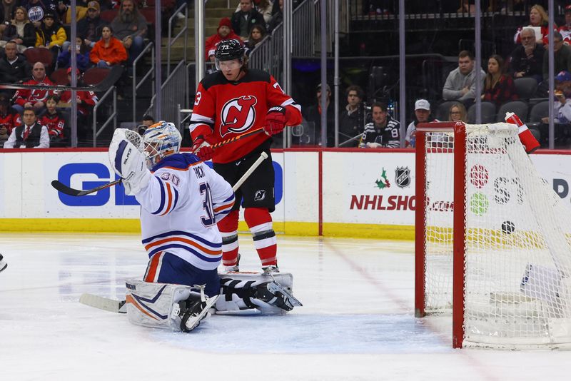 Dec 21, 2023; Newark, New Jersey, USA; New Jersey Devils defenseman Jonas Siegenthaler (71) (not shown) scores a goal against the Edmonton Oilers during the second period at Prudential Center. Mandatory Credit: Ed Mulholland-USA TODAY Sports