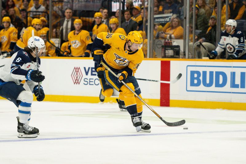 Nov 23, 2024; Nashville, Tennessee, USA;  Nashville Predators left wing Cole Smith (36) skates with the puck against against the Winnipeg Jets during the third period at Bridgestone Arena. Mandatory Credit: Steve Roberts-Imagn Images