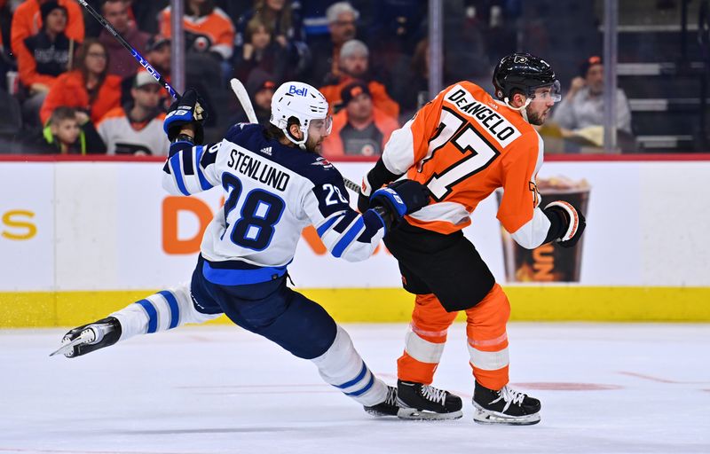 Jan 22, 2023; Philadelphia, Pennsylvania, USA; Winnipeg Jets center Kevin Stenlund (28) scores an open-net goal against Philadelphia Flyers defenseman Tony DeAngelo (77) in the third period at Wells Fargo Center. Mandatory Credit: Kyle Ross-USA TODAY Sports