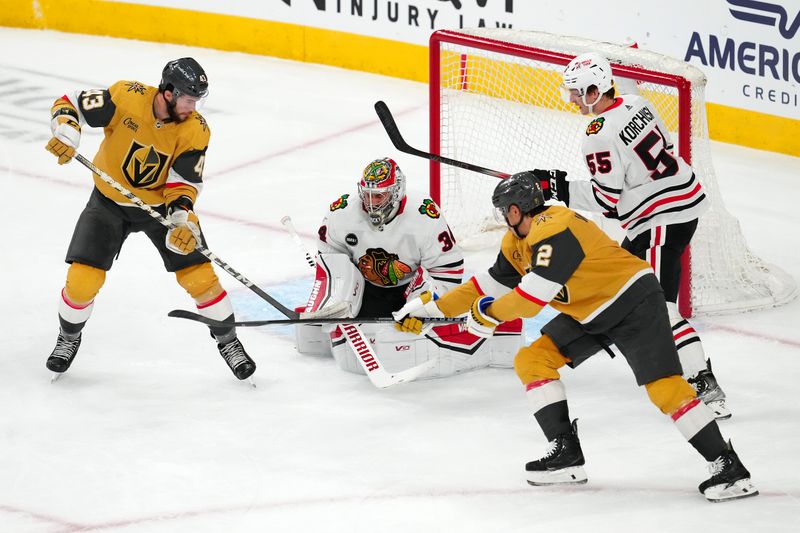 Apr 16, 2024; Las Vegas, Nevada, USA; Chicago Blackhawks goaltender Petr Mrazek (34) makes a save as Vegas Golden Knights center Paul Cotter (43) and defenseman Zach Whitecloud (2) attempt a deflection in front of Chicago Blackhawks defenseman Kevin Korchinski (55) during the first period at T-Mobile Arena. Mandatory Credit: Stephen R. Sylvanie-USA TODAY Sports