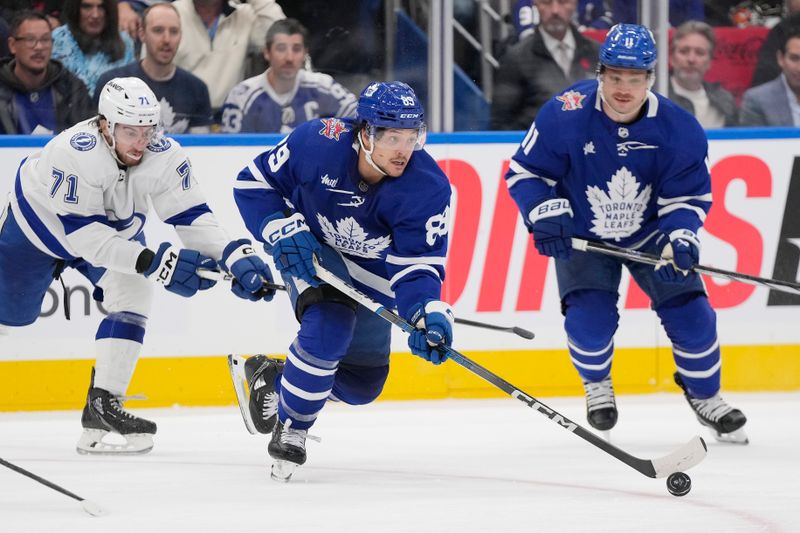 Nov 6, 2023; Toronto, Ontario, CAN; Toronto Maple Leafs forward Nicholas Robertson (89) carries the puck past Tampa Bay Lightning forward Anthony Cirelli (71) during the third period at Scotiabank Arena. Mandatory Credit: John E. Sokolowski-USA TODAY Sports