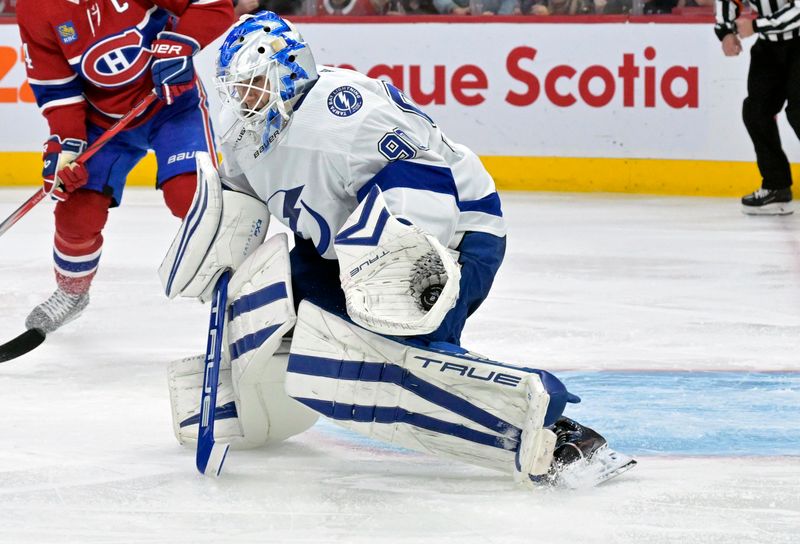 Nov 7, 2023; Montreal, Quebec, CAN; Tampa Bay Lightning goalie Matt Tomkins (90) makes a glove save during the third period of the game against the Montreal Canadiens at the Bell Centre. Mandatory Credit: Eric Bolte-USA TODAY Sports