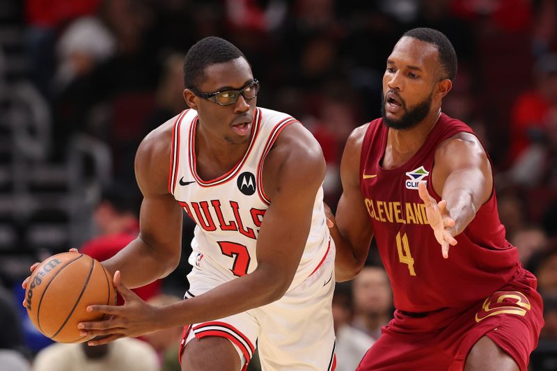 CHICAGO, ILLINOIS - OCTOBER 18: Jalen Smith #7 of the Chicago Bulls is defended by Evan Mobley #4 of the Cleveland Cavaliers during the first half of a preseason game at the United Center on October 18, 2024 in Chicago, Illinois. NOTE TO USER: User expressly acknowledges and agrees that, by downloading and or using this photograph, User is consenting to the terms and conditions of the Getty Images License Agreement.  (Photo by Michael Reaves/Getty Images)