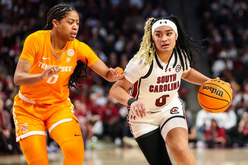 Mar 3, 2024; Columbia, South Carolina, USA; South Carolina Gamecocks guard Te-Hina Paopao (0) drives around Tennessee Lady Vols guard Jewel Spear (0) in the first half at Colonial Life Arena. Mandatory Credit: Jeff Blake-USA TODAY Sports