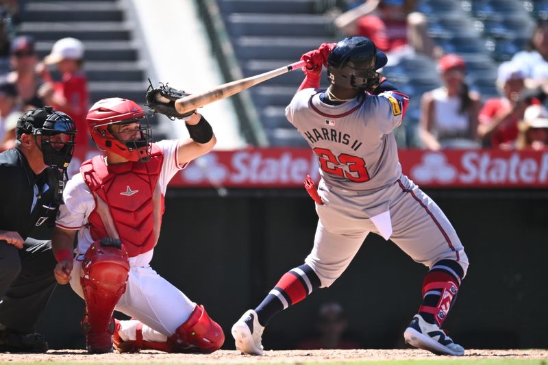 Aug 18, 2024; Anaheim, California, USA; Los Angeles Angels catcher Matt Thaiss (21) makes a catch against Atlanta Braves outfielder Michael Harris II (23) during the seventh inning at Angel Stadium. Mandatory Credit: Jonathan Hui-USA TODAY Sports