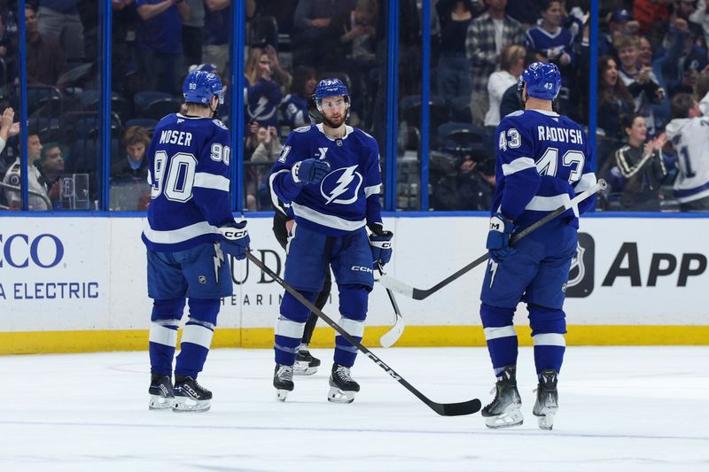 Dec 22, 2025; Tampa, Florida, USA; Tampa Bay Lightning center Anthony Cirelli (71) reacts with defenseman J.J. Moser (90) and defenseman Darren Raddysh (43) after scoring a goal against the St. Louis Blues in the second period at Benchmark International Arena. Mandatory Credit: Nathan Ray Seebeck-Imagn Images