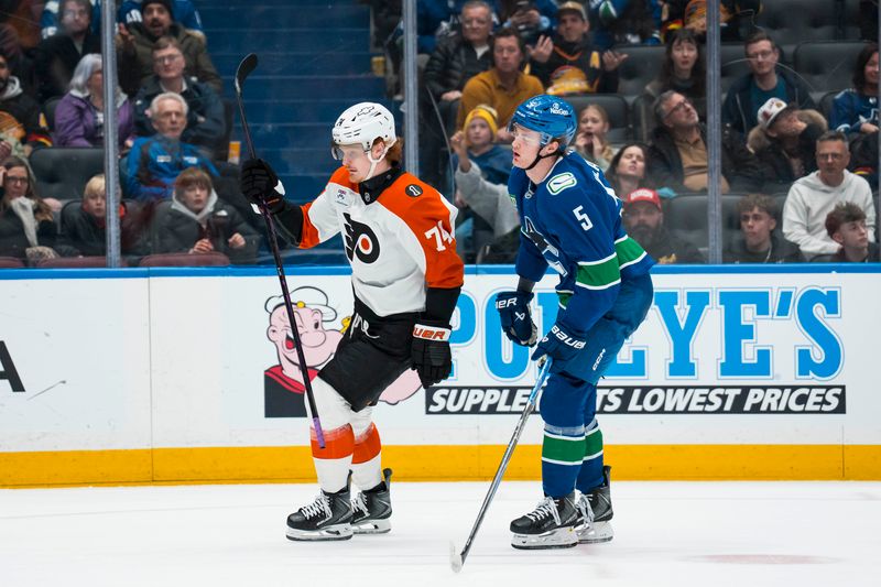 Dec 30, 2025; Vancouver, British Columbia, CAN; Vancouver Canucks defenseman Tom Willander (5) reacts as Philadelphia Flyers forward Owen Tippett (74) celebrates his goal in the third period at Rogers Arena. Mandatory Credit: Bob Frid-Imagn Images