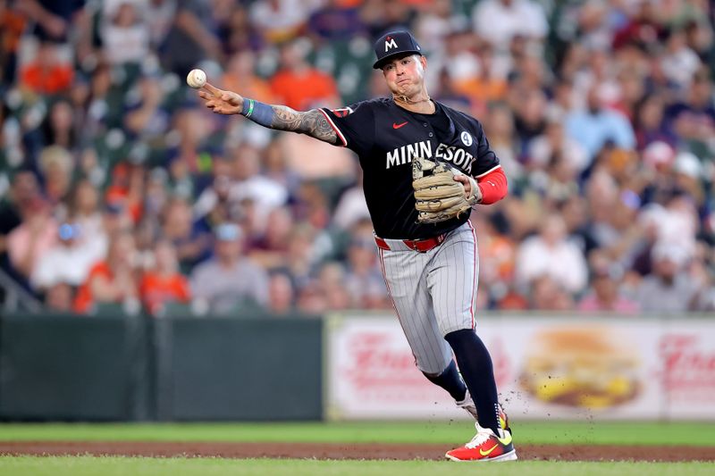 Jun 2, 2024; Houston, Texas, USA; Minnesota Twins third baseman Jose Miranda (64) throws a fielded ball to first for an out against the Houston Astros during the second inning at Minute Maid Park. Mandatory Credit: Erik Williams-USA TODAY Sports