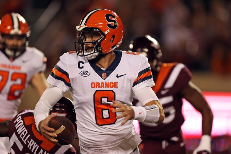 Oct 26, 2023; Blacksburg, Virginia, USA; Syracuse Orange quarterback Garrett Shrader (6) runs away from Virginia Tech Hokies defensive lineman Antwaun Powell-Ryland (52) during the first quarter at Lane Stadium. Mandatory Credit: Peter Casey-USA TODAY Sports