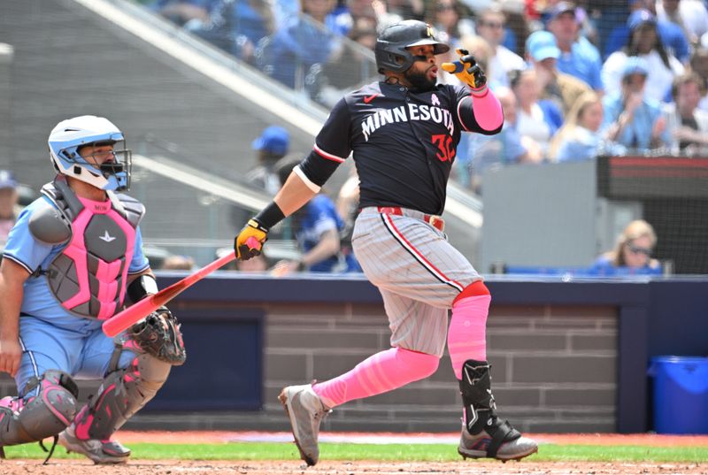 May 12, 2024; Toronto, Ontario, CAN;  Minnesota Twins first baseman Carlos Santana (30) hits a single against the Toronto Blue Jays in the fifth  inning at Rogers Centre. Mandatory Credit: Dan Hamilton-USA TODAY Sports