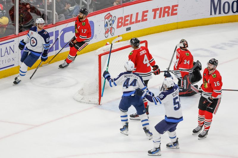 Feb 23, 2024; Chicago, Illinois, USA; Winnipeg Jets left wing Kyle Connor (81) celebrates after scoring a game winning goal against the Chicago Blackhawks during overtime at United Center. Mandatory Credit: Kamil Krzaczynski-USA TODAY Sports