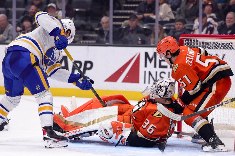 Nov 22, 2024; Anaheim, California, USA; Buffalo Sabres defenseman Bowen Byram (4) shoots against Anaheim Ducks goaltender John Gibson (36) and defenseman Olen Zellweger (51) during the third period at Honda Center. Mandatory Credit: Ryan Sun-Imagn Images