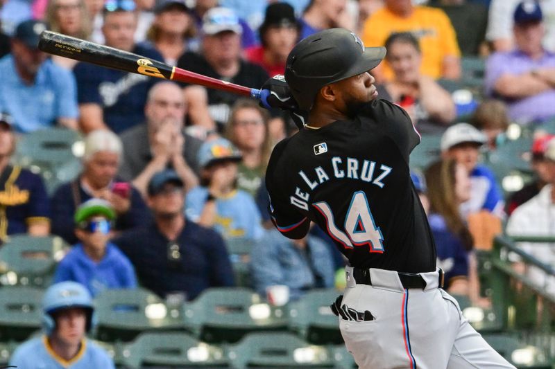 Jul 26, 2024; Milwaukee, Wisconsin, USA; Miami Marlins left fielder Bryan De La Cruz (14) hits a two-run home run in the first inning against the Milwaukee Brewers at American Family Field. Mandatory Credit: Benny Sieu-USA TODAY Sports