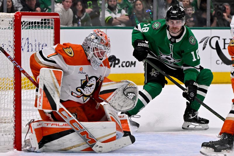 Mar 18, 2025; Dallas, Texas, USA; Anaheim Ducks goaltender Lukas Dostal (1) stops a shot as Dallas Stars center Sam Steel (18) looks for the rebound during the second period at the American Airlines Center. Mandatory Credit: Jerome Miron-Imagn Images
