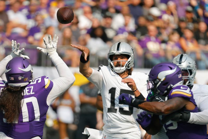 Las Vegas Raiders quarterback Gardner Minshew II (15) throws against the Minnesota Vikings during the first half of an NFL football game Saturday, Aug. 10, 2024, in Minneapolis. (AP Photo/Bruce Kluckhohn)