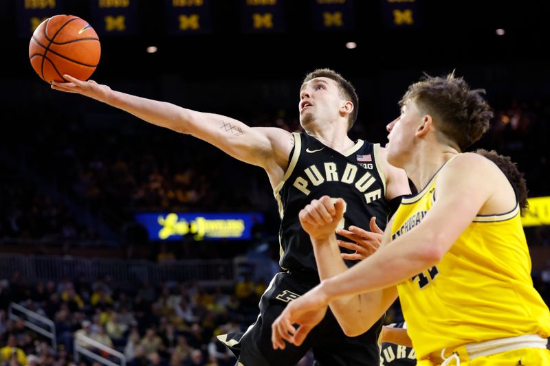 Feb 25, 2024; Ann Arbor, Michigan, USA;  Purdue Boilermakers guard Braden Smith (3) shoots on Michigan Wolverines forward Will Tschetter (42) in the second half at Crisler Center. Mandatory Credit: Rick Osentoski-USA TODAY Sports