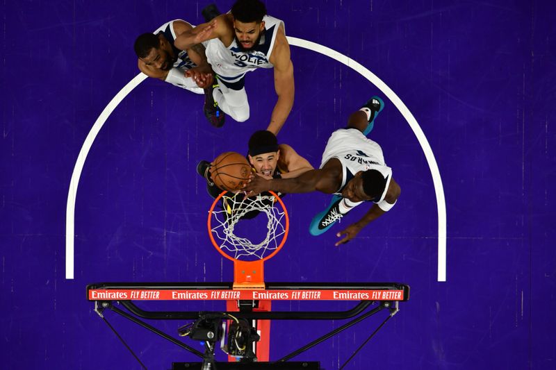 PHOENIX, AZ - APRIL  28: Anthony Edwards #5 of the Minnesota Timberwolves blocks the shot by Devin Booker #1 of the Phoenix Suns during the game during Round 1 Game 4 of the 2024 NBA Playoffs on April 28, 2024 at Footprint Center in Phoenix, Arizona. NOTE TO USER: User expressly acknowledges and agrees that, by downloading and or using this photograph, user is consenting to the terms and conditions of the Getty Images License Agreement. Mandatory Copyright Notice: Copyright 2024 NBAE (Photo by Kate Frese/NBAE via Getty Images)