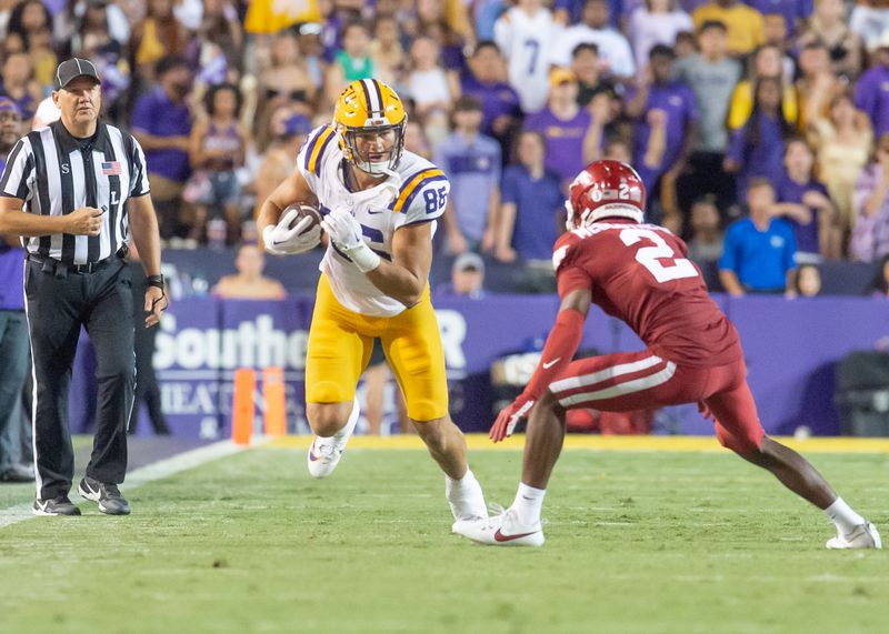 Sep 23, 2023; Baton Rouge, Louisiana, USA; LSU Tigers tight end Mason Taylor (86) runs the ball against Arkansas Razorbacks defensive back Dwight McGlothern (2) during the game at Tiger Stadium. Mandatory Credit: Scott Clause-USA TODAY Sports