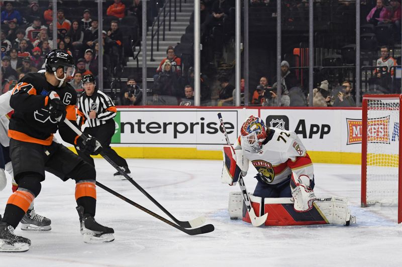 Jan 13, 2025; Philadelphia, Pennsylvania, USA; Florida Panthers goaltender Sergei Bobrovsky (72) makes a save against Philadelphia Flyers center Sean Couturier (14) during the first period at Wells Fargo Center. Mandatory Credit: Eric Hartline-Imagn Images