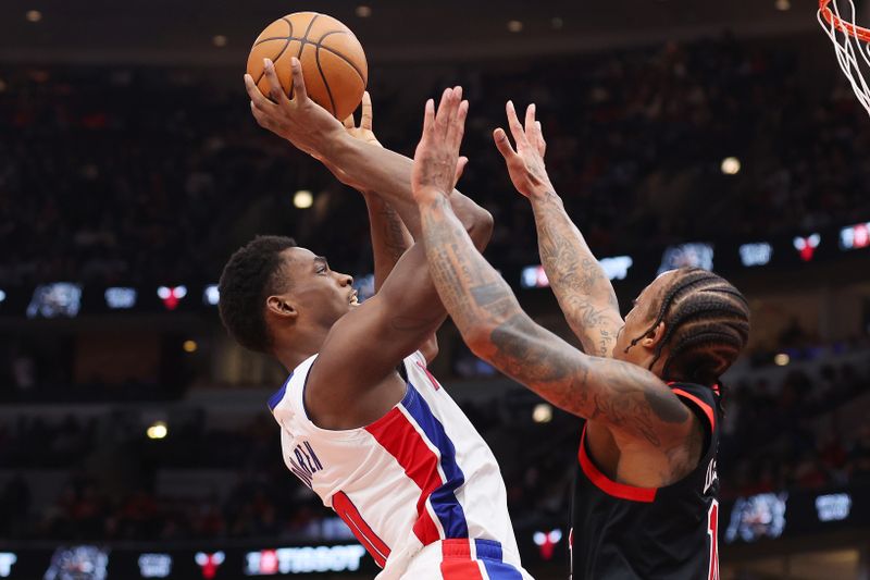 CHICAGO, ILLINOIS - FEBRUARY 27: Jalen Duren #0 of the Detroit Pistons shoots over DeMar DeRozan #11 of the Chicago Bulls during the second half at the United Center on February 27, 2024 in Chicago, Illinois. NOTE TO USER: User expressly acknowledges and agrees that, by downloading and or using this photograph, User is consenting to the terms and conditions of the Getty Images License Agreement. (Photo by Michael Reaves/Getty Images)