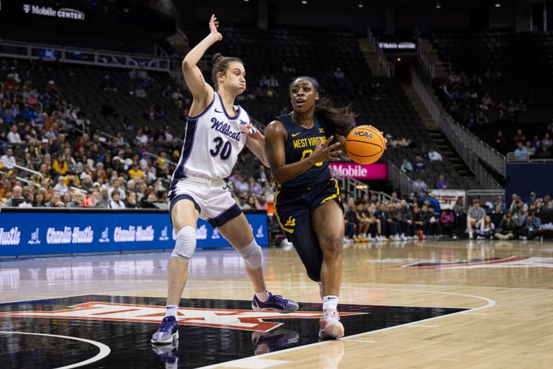 Mar 9, 2024; Kansas City, MO, USA; West Virginia Mountaineers guard Jayla Hemingway (00) handles the ball while defended by Kansas State Wildcats forward Gisela Sanchez (30) during the first half at T-Mobile Center. Mandatory Credit: Amy Kontras-USA TODAY Sports