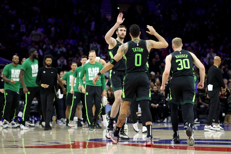 PHILADELPHIA, PENNSYLVANIA - FEBRUARY 02: Luke Kornet #40 of the Boston Celtics high fives Jayson Tatum #0 during the second half against the Philadelphia 76ers at the Wells Fargo Center on February 02, 2025 in Philadelphia, Pennsylvania. NOTE TO USER: User expressly acknowledges and agrees that, by downloading and or using this photograph, User is consenting to the terms and conditions of the Getty Images License Agreement. (Photo by Emilee Chinn/Getty Images)