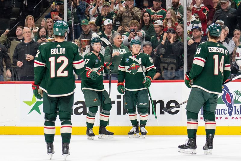 Apr 4, 2024; Saint Paul, Minnesota, USA; Minnesota Wild defenseman Declan Chisholm (47) is congratulated by teammates after scoring on the Colorado Avalanche in the second period at Xcel Energy Center. Mandatory Credit: Matt Blewett-USA TODAY Sports