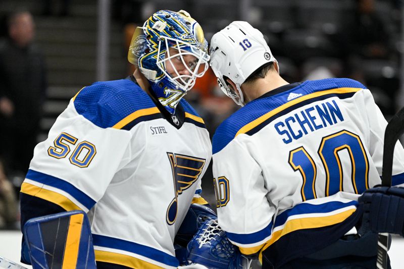 Mar 25, 2023; Anaheim, California, USA; St. Louis Blues goalie Jordan Binnington (50) celebrates with center Brayden Schenn (10) after the game against the Anaheim Ducks at Honda Center. Mandatory Credit: Kelvin Kuo-USA TODAY Sports