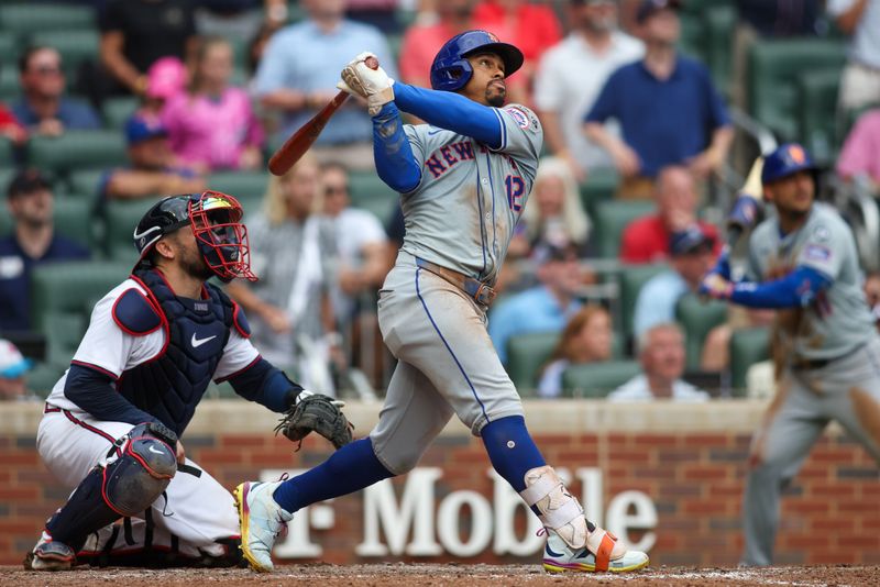 Sep 30, 2024; Atlanta, Georgia, USA; New York Mets shortstop Francisco Lindor (12) hits a two-run home run against the Atlanta Braves in the ninth inning at Truist Park. Mandatory Credit: Brett Davis-Imagn Images