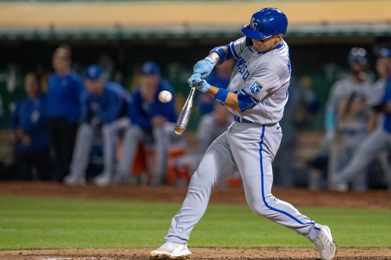 Aug 21, 2023; Oakland, California, USA;  Kansas City Royals designated hitter Michael Massey (19) hits a RBI single against the Oakland Athletics during the eighth inning at Oakland-Alameda County Coliseum. Mandatory Credit: Neville E. Guard-USA TODAY Sports