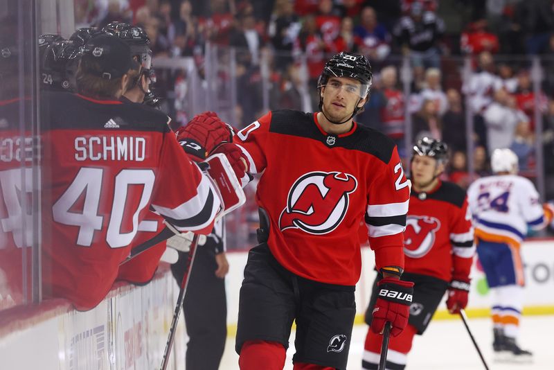 Nov 28, 2023; Newark, New Jersey, USA; New Jersey Devils center Michael McLeod (20) celebrates his goal against the New York Islanders during the first period at Prudential Center. Mandatory Credit: Ed Mulholland-USA TODAY Sports