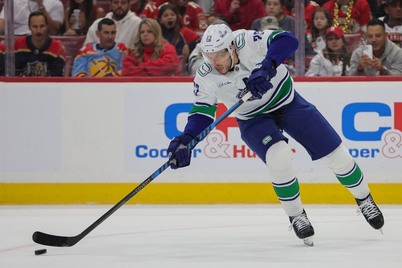 Oct 17, 2024; Sunrise, Florida, USA; Vancouver Canucks defenseman Vincent Desharnais (73) moves the puck against the Florida Panthers during the third period at Amerant Bank Arena. Mandatory Credit: Sam Navarro-Imagn Images