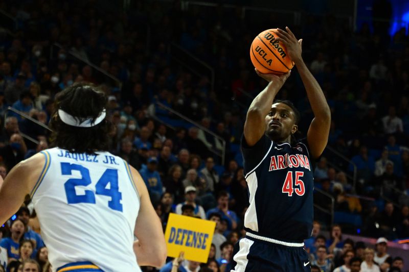 Mar 4, 2023; Los Angeles, California, USA;  Arizona Wildcats guard Cedric Henderson Jr. (45) shoots for the basket as UCLA Bruins guard Jaime Jaquez Jr. (24) defends during the first half at Pauley Pavilion presented by Wescom. Mandatory Credit: Richard Mackson-USA TODAY Sports