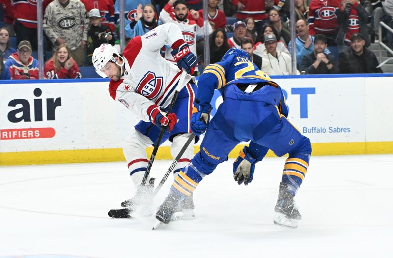 Nov 11, 2024; Buffalo, New York, USA; Montreal Canadiens right wing Josh Anderson (17) tries to shoot the puck past Buffalo Sabres center Dylan Cozens (24) in the third period at KeyBank Center. Mandatory Credit: Mark Konezny-Imagn Images