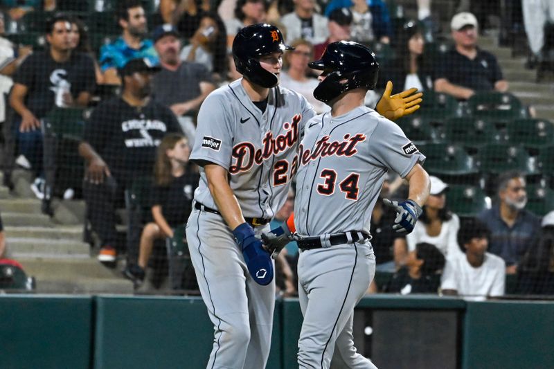 Sep 1, 2023; Chicago, Illinois, USA; Detroit Tigers center fielder Parker Meadows (22), left, congratulates catcher Jake Rogers (34) after scoring against the Chicago White Sox during the fifth inning at Guaranteed Rate Field. Mandatory Credit: Matt Marton-USA TODAY Sports