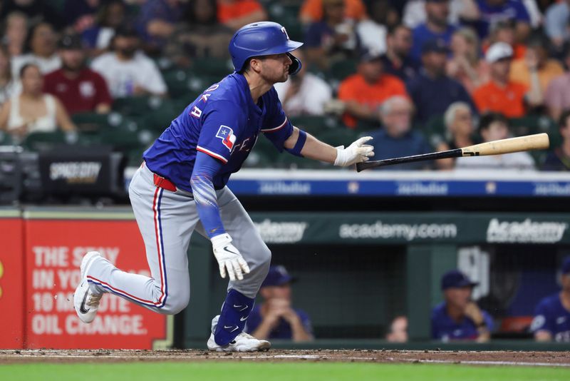 Sep 16, 2025; Houston, Texas, USA; Texas Rangers catcher Kyle Higashioka (11) hits a single during the second inning against the Houston Astros at Daikin Park. Mandatory Credit: Troy Taormina-Imagn Images