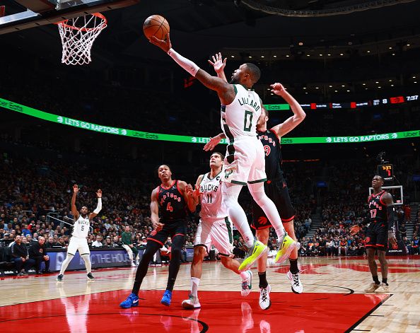 TORONTO, CANADA - NOVEMBER 15:  Damian Lillard #0 of the Milwaukee Bucks drives to the basket during the game against the Toronto Raptors on November 15, 2023 at the Scotiabank Arena in Toronto, Ontario, Canada.  NOTE TO USER: User expressly acknowledges and agrees that, by downloading and or using this Photograph, user is consenting to the terms and conditions of the Getty Images License Agreement.  Mandatory Copyright Notice: Copyright 2023 NBAE (Photo by Vaughn Ridley/NBAE via Getty Images)