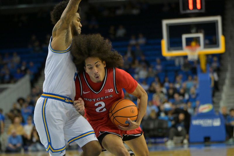Feb 3, 2026; Los Angeles, California, USA;  Rutgers Scarlet Knights guard Lino Mark (2) is defended by UCLA Bruins guard Donovan Dent (2)as he drives to the basket in the second half at Pauley Pavilion presented by Wescom Financial. Mandatory Credit: Jayne Kamin-Oncea-Imagn Images