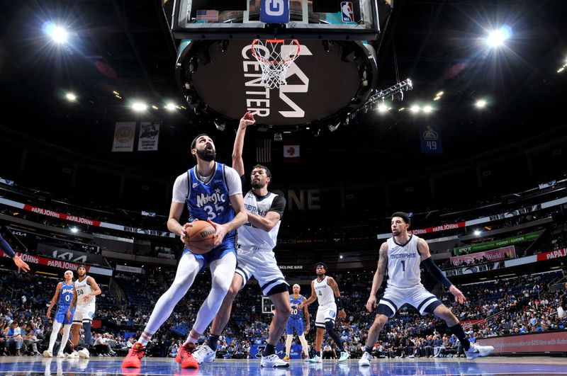 ORLANDO, FL - MARCH 30: Goga Bitadze #35 of the Orlando Magic handles the ball during the game against the Memphis Grizzlies on March 30, 2024 at the Kia Center in Orlando, Florida. NOTE TO USER: User expressly acknowledges and agrees that, by downloading and or using this photograph, User is consenting to the terms and conditions of the Getty Images License Agreement. Mandatory Copyright Notice: Copyright 2024 NBAE (Photo by Fernando Medina/NBAE via Getty Images)