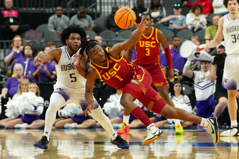 Mar 13, 2024; Las Vegas, NV, USA; USC Trojans guard Isaiah Collier (1) loses control of the ball near Washington Huskies guard Sahvir Wheeler (5) during the first half at T-Mobile Arena. Mandatory Credit: Stephen R. Sylvanie-USA TODAY Sports