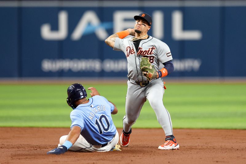 Apr 24, 2024; St. Petersburg, Florida, USA;  Detroit Tigers shortstop Javier Baez (28) throws to first against the Tampa Bay Rays in the second inning at Tropicana Field. Mandatory Credit: Nathan Ray Seebeck-USA TODAY Sports