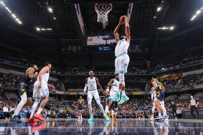 INDIANAPOLIS, IN - MARCH 7: Rudy Gobert #27 of the Minnesota Timberwolves grabs a rebound during the game against the Indiana Pacers on March 7, 2024 at Gainbridge Fieldhouse in Indianapolis, Indiana. NOTE TO USER: User expressly acknowledges and agrees that, by downloading and or using this Photograph, user is consenting to the terms and conditions of the Getty Images License Agreement. Mandatory Copyright Notice: Copyright 2024 NBAE (Photo by Ron Hoskins/NBAE via Getty Images)